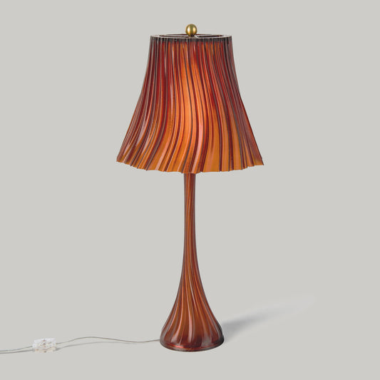 Pleat Wavy lamp lit, showing the pleated shade glow