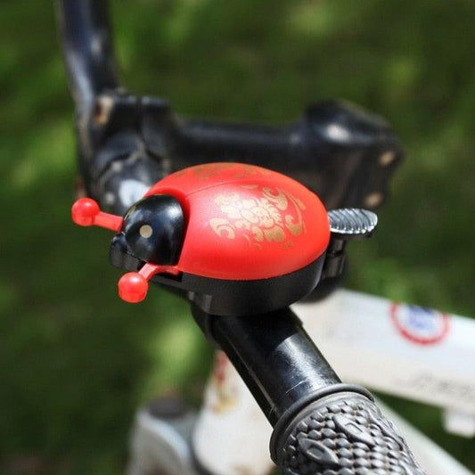 Ladybug bike bell mounted on a handlebar