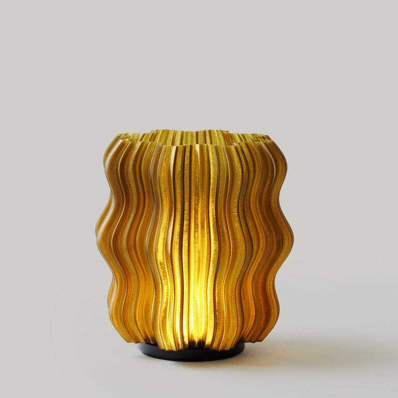 Mini Wavy cordless table lamp in Olive Oil, switched on
