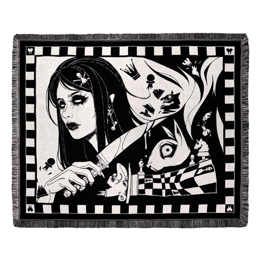 Dark Alice chess blanket draped over a sofa