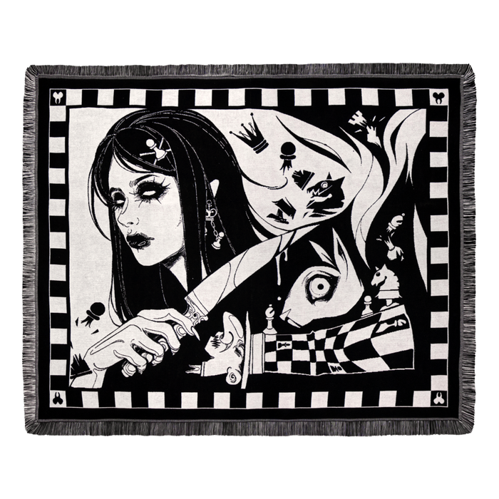 Dark Alice chess blanket draped over a sofa