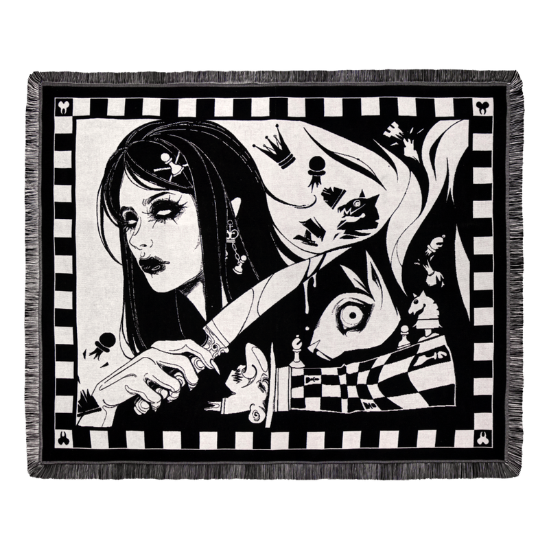 Dark Alice chess blanket draped over a sofa