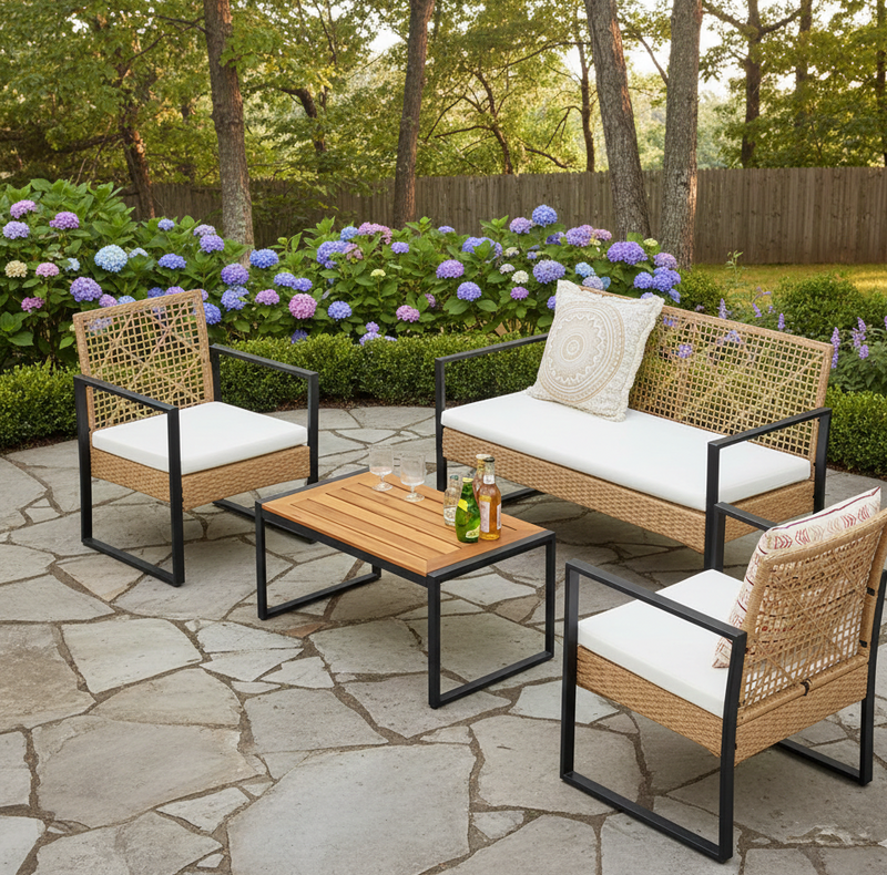 Four-piece rattan wicker patio furniture set with sofa, chairs and table