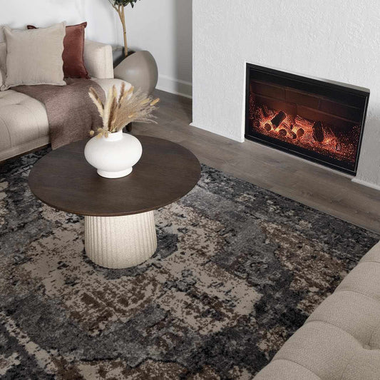 Living room with a fireplace, coffee table, and decorative elements.