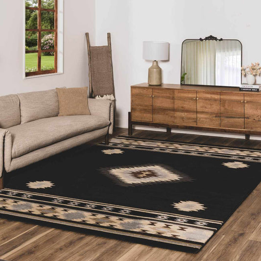 Living room with a black patterned rug, beige sofa, wooden sideboard, and decorative elements.