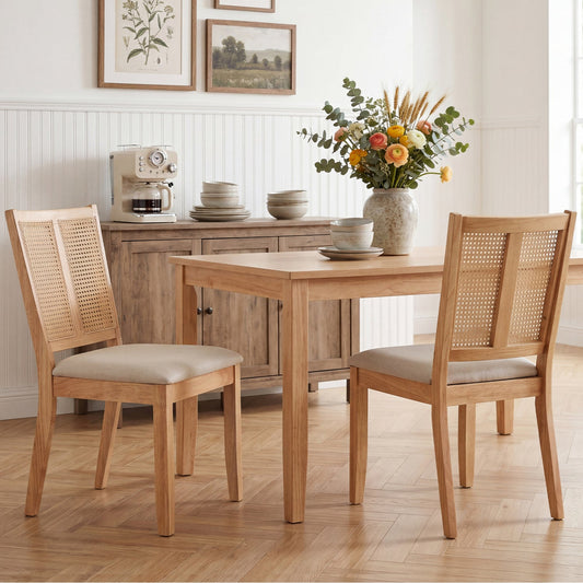 Pair of rattan dining chairs with woven backs and a curved profile